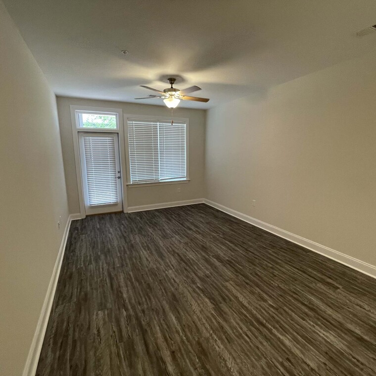 Wood floors and ceiling fan in living room